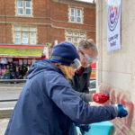 Andrea & Michael clean graffiti off Thornton Heath Clock Tower